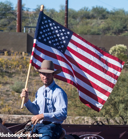 A cowboy carrying the American flag Wickenburg Arizona