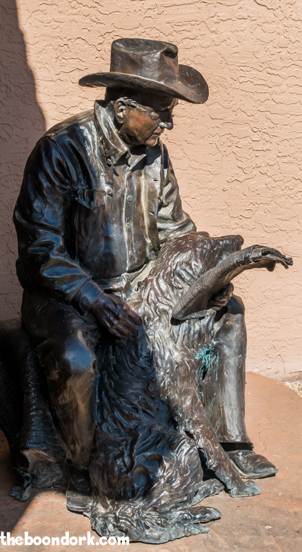 Statue of cowboy reading the newspaper Wickenburg Arizona
