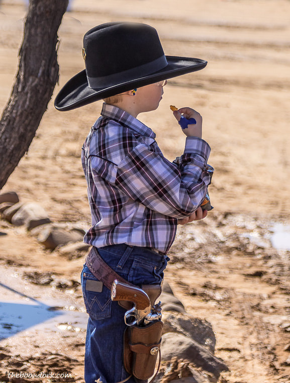 Young cowboy with gun