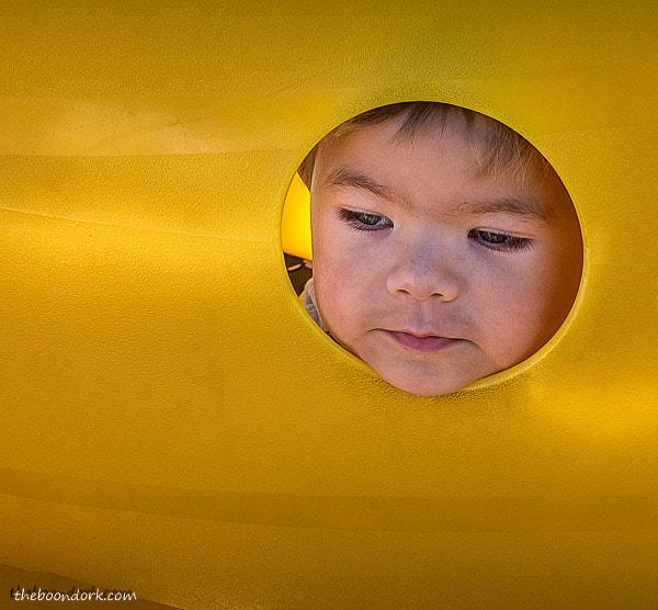 Kid looking out a hole